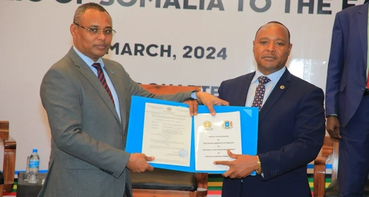 Peter Mathuki receiving Somalia’s instrument of ratification of the Treaty of Accession from Jibril Abdirashid Haji Abdi.