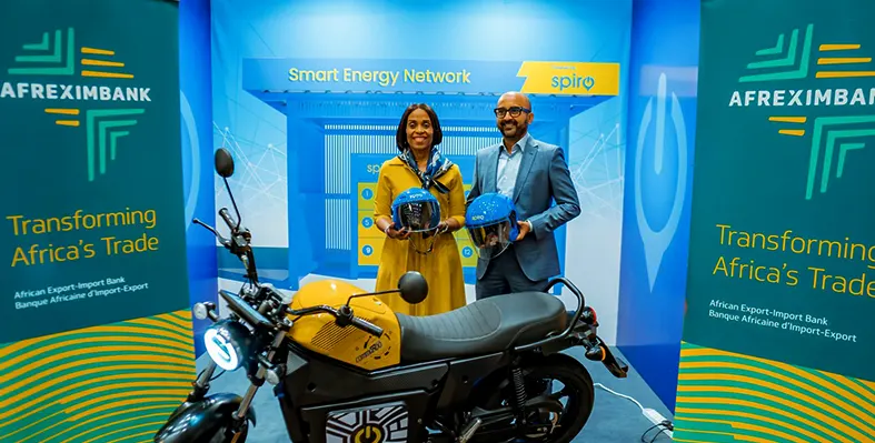 Kaushik Burman and Kanayo Awani at the Africa CEO Forum, posing in front of an electric bike. 