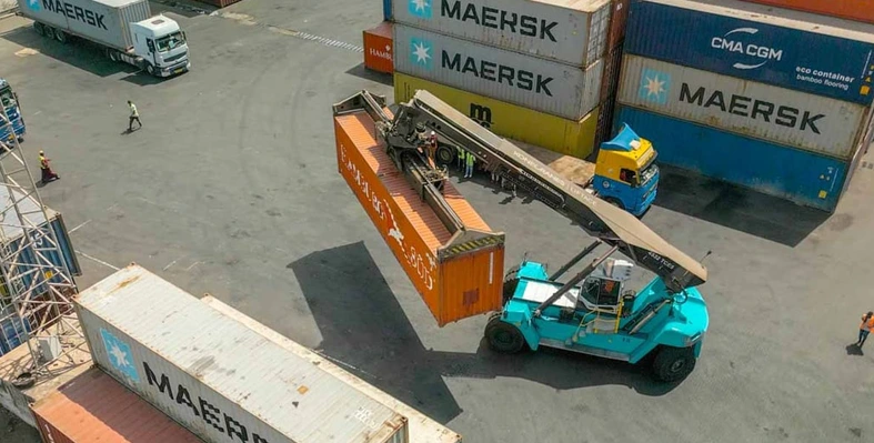 An overhead shot of containers being moved at a port facility.