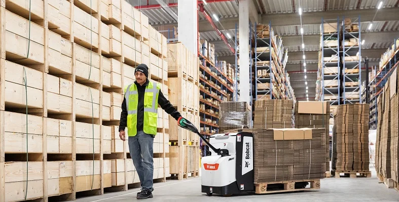 Bobcat machinery in action on a warehouse floor.