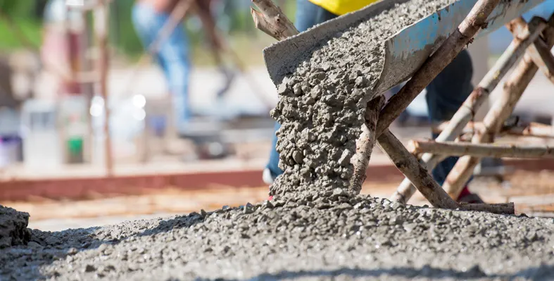 Concrete being poured at a construction site.