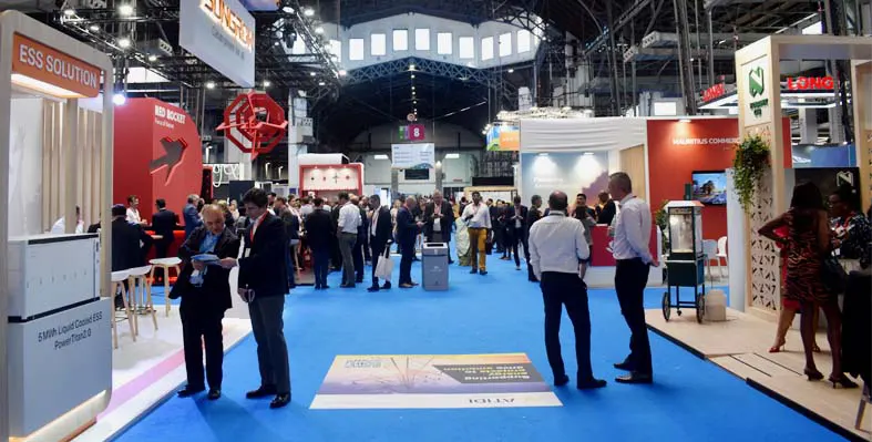 A picture of the exhibition floor from aef with delegates speaking at stands.