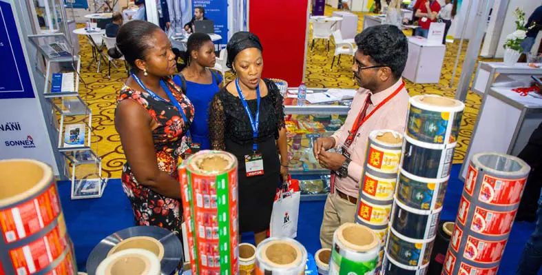Attendees speaking to an exhibitor at Propak Ghana 2023.