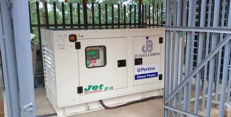 The generator set for the school in Uganda behind metal bars for security.