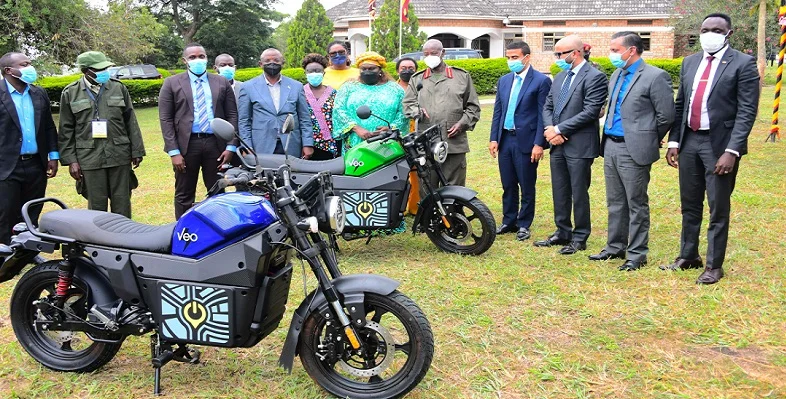Key Ugandan officials and Spiro executives posing for a picture with a Spiro EV bike