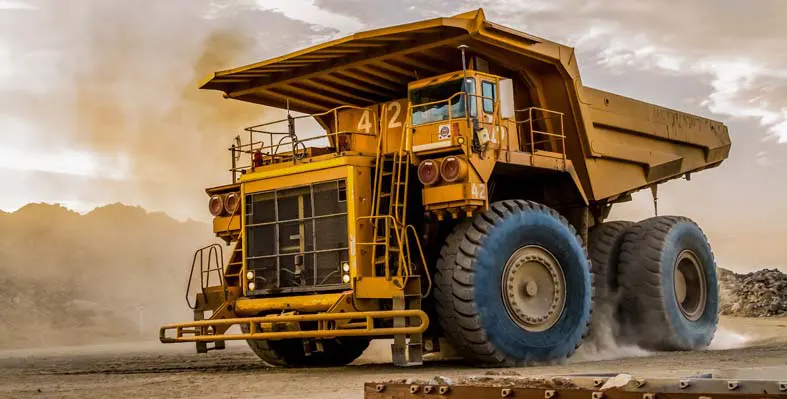 Large mining quarry machinery driving on site