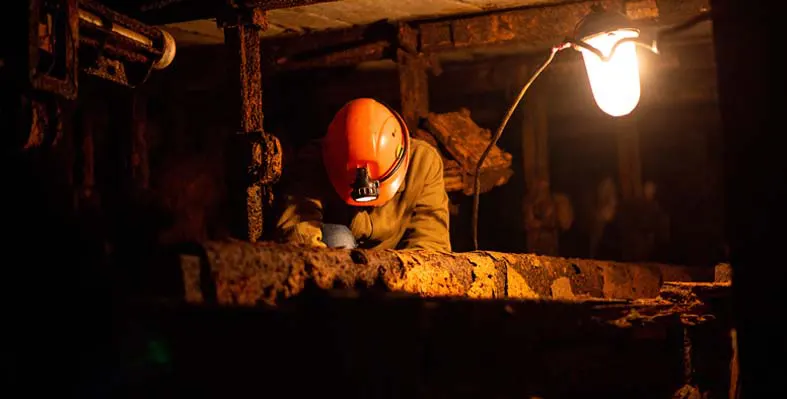 A mine employee at work underground. 