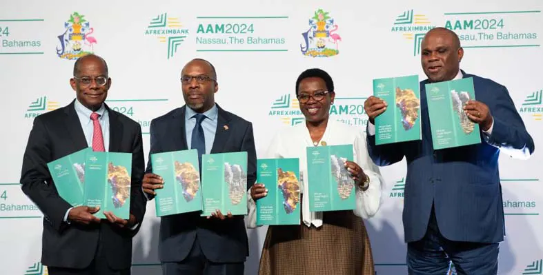 Senior leaders of Afreximbank posing for a picture holding up the two recently released reports.