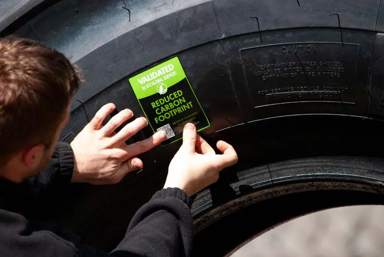 A Kal Tire certificate being stuck on a tyre.