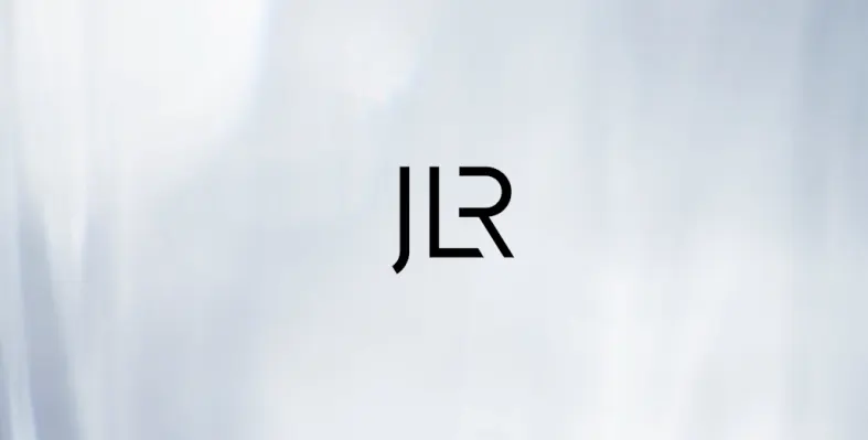 The JLR logo against a grey background.