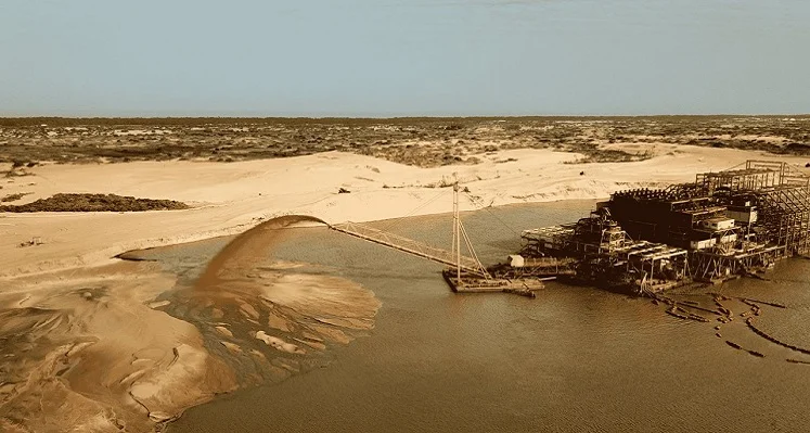 A mineral sands producing mine pouring sand into a pile