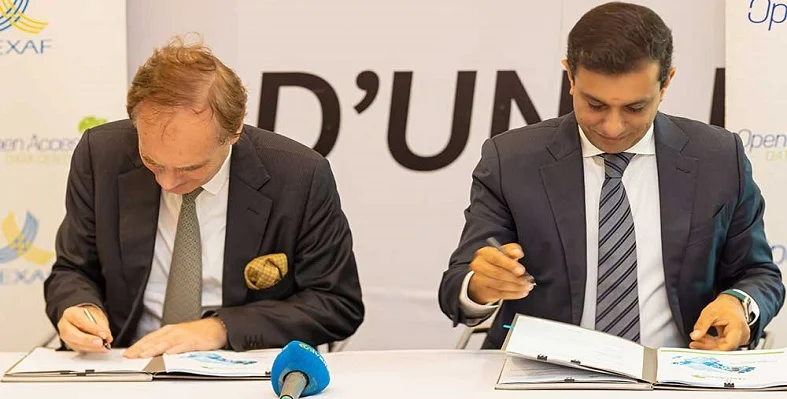 Two executives from Rawbank and OADC signing the agreement.