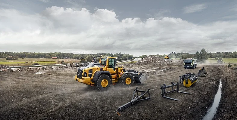 A Volvo wheel loader in action on a construction site.