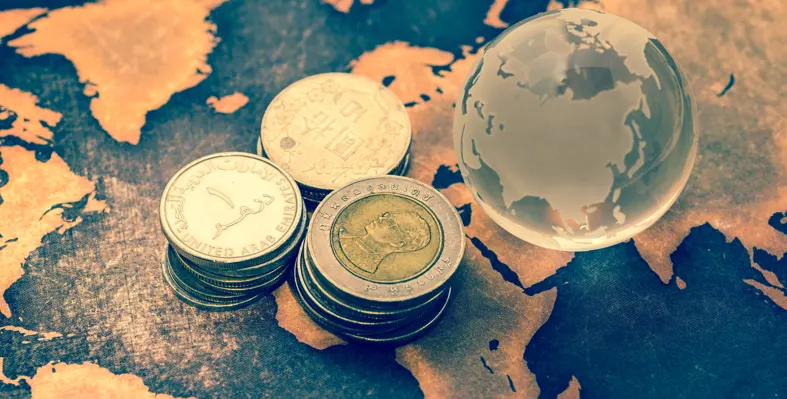 Coins stacked on top of Africa on a world map. 