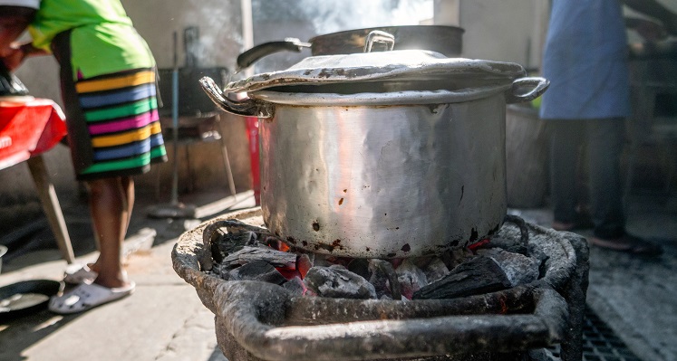A cooking pot over an open fire. 