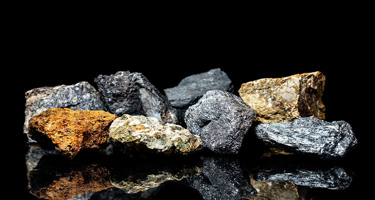 Different mined minerals on a black background.