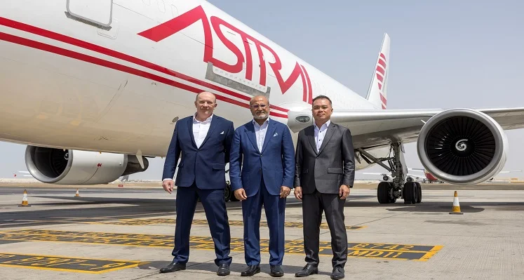 Key leaders from Astral Aviation and Etihad Cargo standing in front of an Astral aeroplane. 