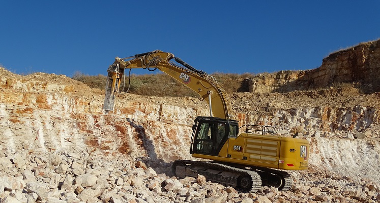 An Indeco hammer in action while mounted on a Caterpillar excavator. 