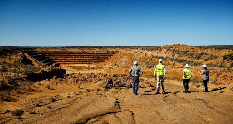 Consultants overlooking a large mining pit. 