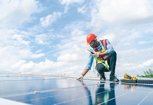 This partnership will help to increase the share of renewable energies in installed capacity to 40% of Senegal’s electricity mix by 2030 Man_working_solar_panel