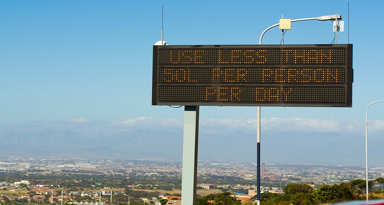An electronic road sign reading use less than 50L per person per day.