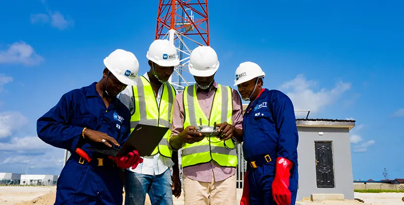 Four_construction_workers_at_the_site_with_laptop_and_phone