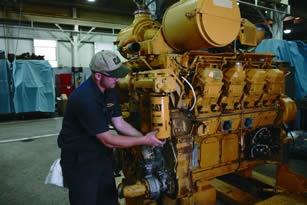 Caterpillar_technician_servicing_a_Cat_3508_marine_engine