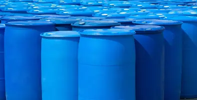Plastic drum barrels for industrial applications arranged in front of each other against a plain background. 