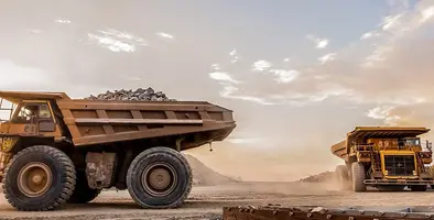 Two mining trucks working on a site. 