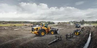 A Volvo wheel loader in action on a construction site.