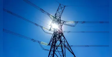 Electrical-transmission-tower-blue-sky-sun