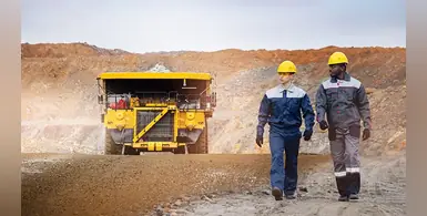 Engineers-open-pit-mine-mining-truck-in-background 