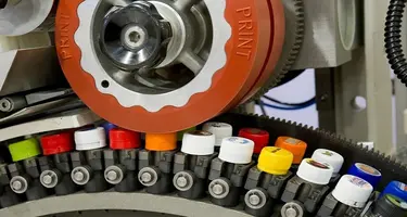 An image of a printer machine in action with various colours. 