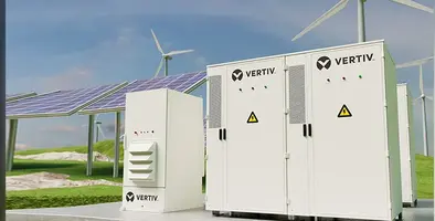 Vertiv DynaFlex BESS with solar panels and wind turbines in the background.