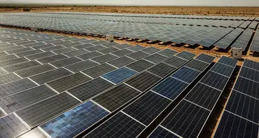 An overhead shot of a solar farm with hundreds of panels. 