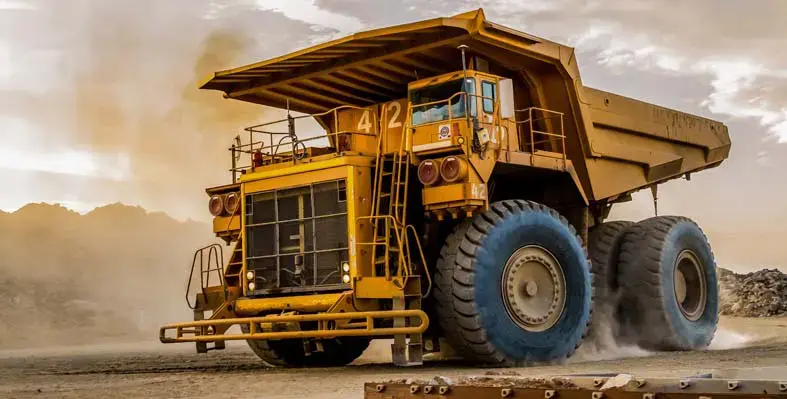 Large mining quarry machinery driving on site