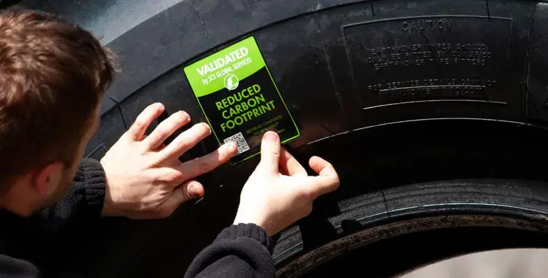 A Kal Tire certificate being stuck on a tyre.
