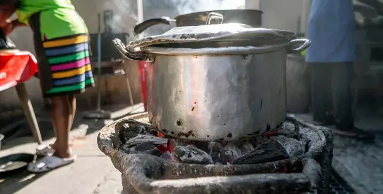 A cooking pot over an open fire. 