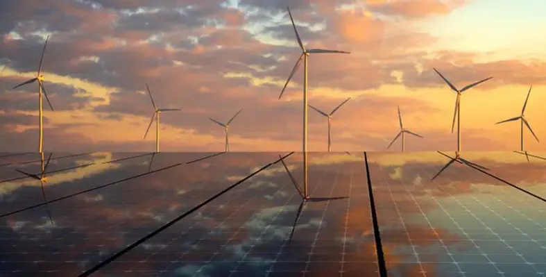 An image depicting solar panels in the foreground with wind turbines behind. 