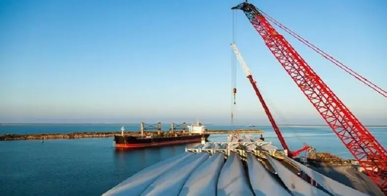 A picture from a cargo ship looking at another one in a port. 