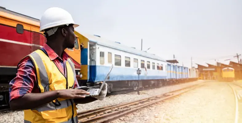 Rail_engineer_standing_by_train_rail_line