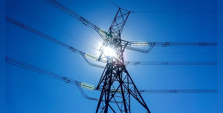 Electrical-transmission-tower-blue-sky-sun