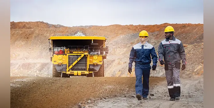 Engineers-open-pit-mine-mining-truck-in-background 