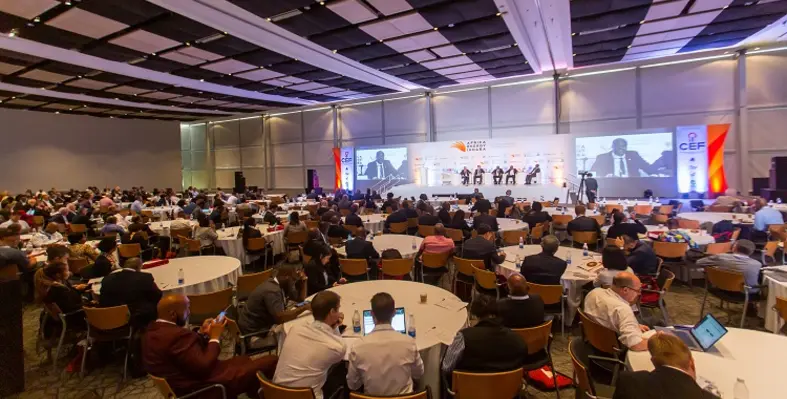 The conference hall of Africa Energy Indaba 2023 with participants speaking. 