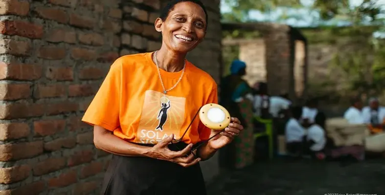A solar sister holding a light. 