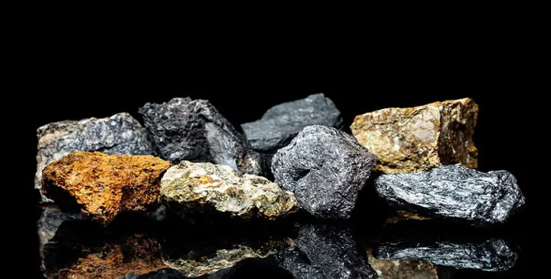 Different mined minerals on a black background.