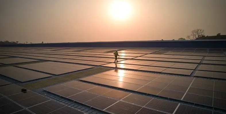 An engineer walking across a large platform of solar panels installed by Daystar Power.