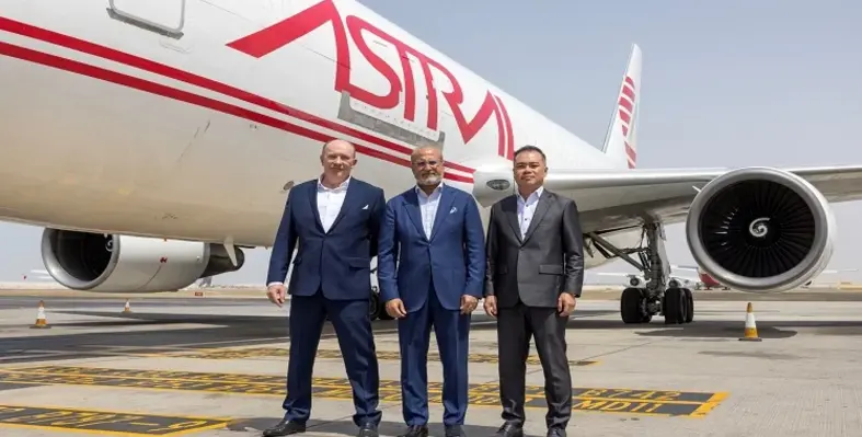 Key leaders from Astral Aviation and Etihad Cargo standing in front of an Astral aeroplane. 
