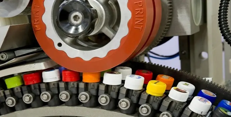 An image of a printer machine in action with various colours. 