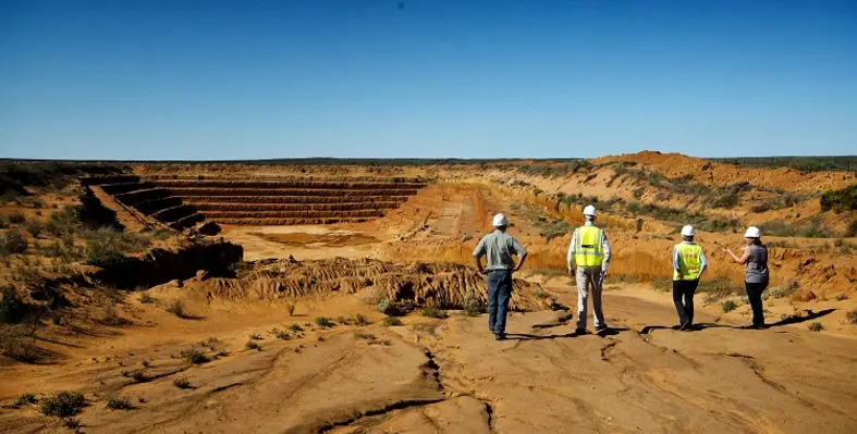 Consultants overlooking a large mining pit. 